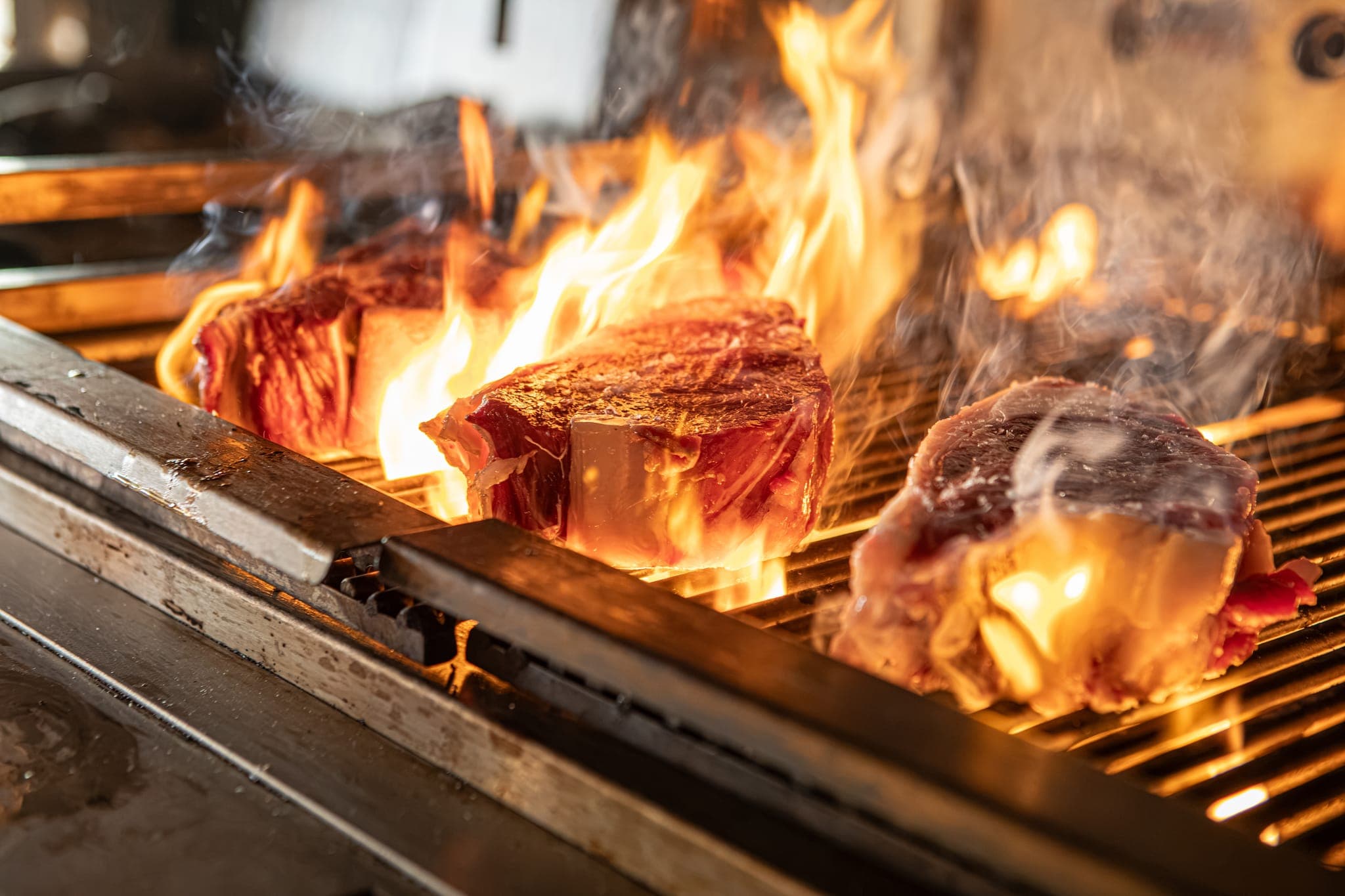 Steaks in the flames on the grill at The Copse.