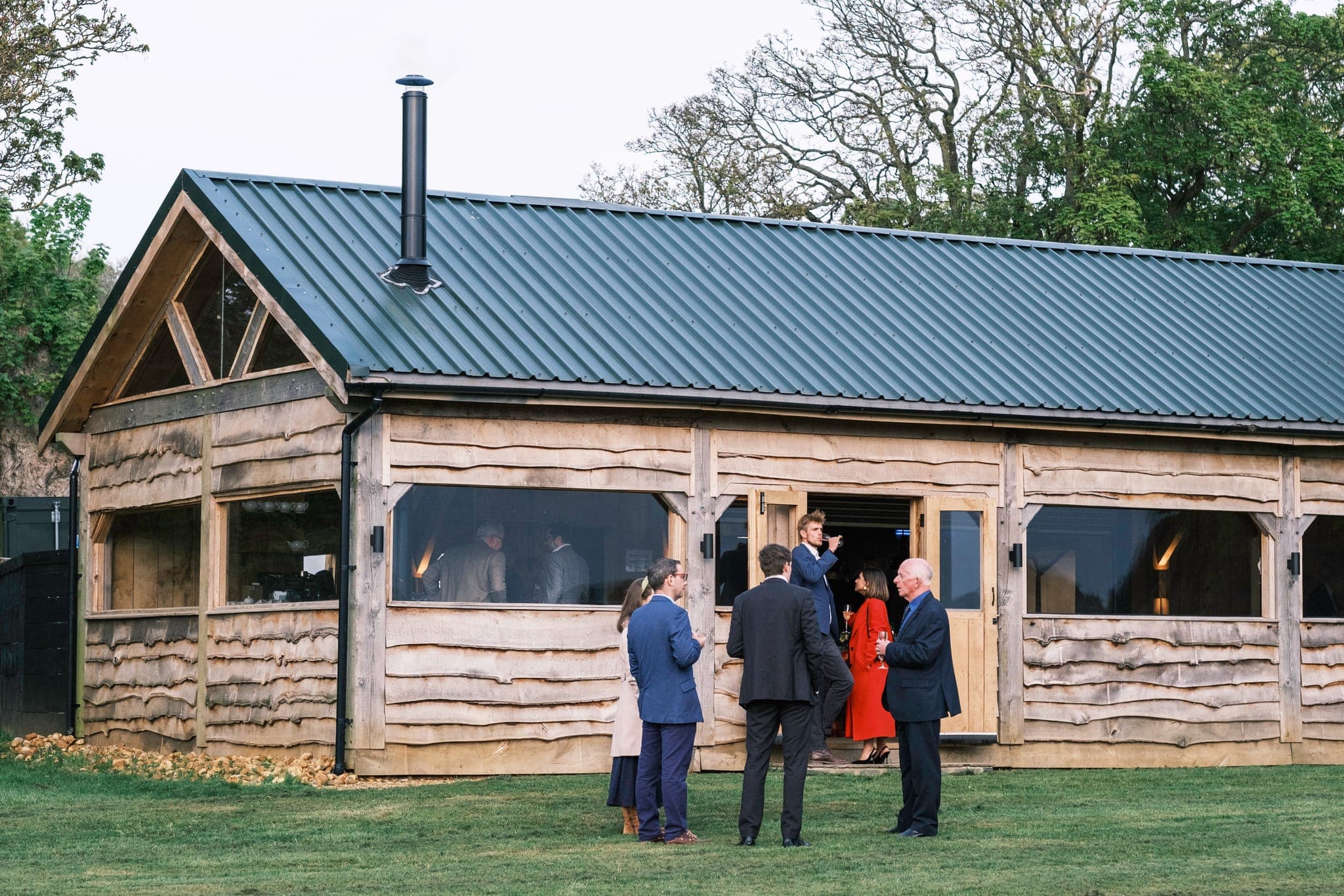 Guests gathering outside the timber barn at The Copse.